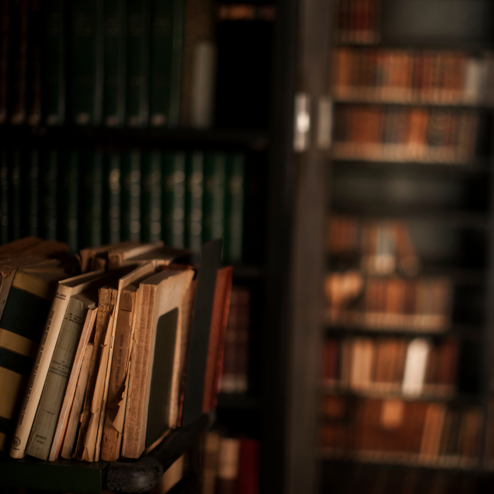 Old books and library shelves, representing knowledge and self-discovery in counselling