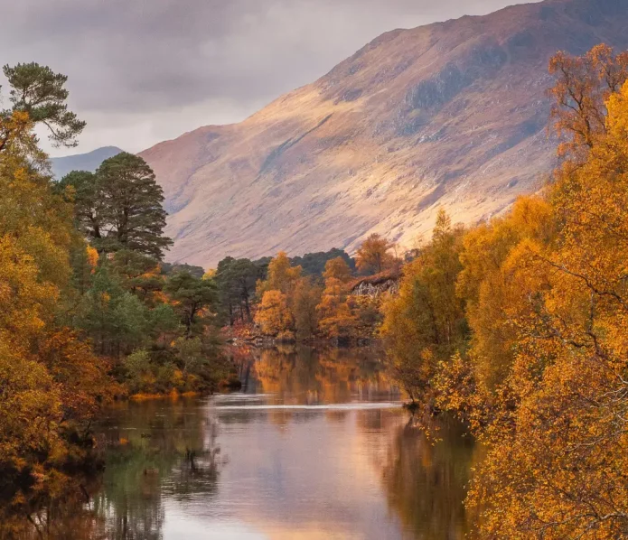 Tranquil river and mountains in autumn, peaceful reflection in nature